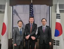 Lee Jun-il (R), director general for North Korean nuclear affairs at the ministry, and U.S. and Japanese representatives, Lyn Debevoise (C) and Naoki Kumagai, respectively, pose for a photo as they meet for the second session of a trilateral working group on North Korean cyberthreats in Washington on March 29, 2024 in this photo released by the ministry. (PHOTO NOT FOR SALE) (Yonhap)