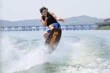 A person enjoys wakeboarding, in this file photo taken April 14, 2024, when the daytime temperature surged to over 25 C in most parts of the country. (Yonhap)