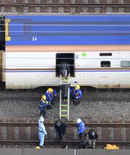 Photo taken from a Kyodo News helicopter shows passengers disembarking from a shinkansen bullet train stopped on the tracks in Saitama, near Tokyo, on Jan. 23, 2024. (Kyodo)
