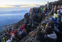 Photo taken in August 2023 shows the summit of Mt. Fuji crowded with climbers who gathered to see the sunrise. (Photo courtesy of Yamanashi prefectural government)(Kyodo)