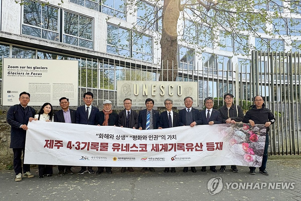 Bereaved family members of victims of a 1948-1954 massacre on South Korea's largest island of Jeju and other people pose for a group photo in front of the UNESCO headquarters in Paris on April 10, 2025, after archives documenting the Jeju April 3 uprising, caused by an ideological rift between residents of Jeju Island and the mainland government, were added to UNESCO's Memory of the World Register, in this photo released by the Jeju municipal government. (PHOTO NOT FOR SALE) (Yonhap) (END)