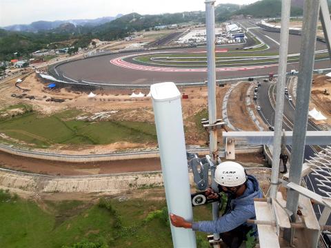 A technician setting up hardware in a BTS tower near Mandalika circuit, Antarafoto,