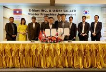This photo taken on Feb. 22, 2024, and provided by E-Mart shows U-Dee Co.'s representative Viengthong chanlivong (L, front) and Executive Vice President Song Man-joon (R, front) in charge of the global business office at E-Mart posing for a photo after signing a master franchise agreement at Kolao Tower in Laos. (PHOTO NOT FOR SALE) (Yonhap)