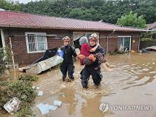 This photo, provided by fire authorities, shows rescuers evacuating a villager in Wanju on July 10, 2024. (PHOTO NOT FOR SALE) (Yonhap)