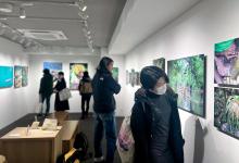 Visitors appreciating portraits of indigenous people from the Batek and Semaq tribes exhibited at the Pictorico Gallery in Tokyo Japan in January.