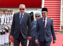 Malaysian Prime Minister Anwar Ibrahim (right) accompanies Turkish President Recep Tayyip Erdogan as they inspect a guard of honour consisting of 28 officers and men from the First Battalion of the Royal Ranger Regiment (Ceremonial) at the Bunga Raya Complex of Kuala Lumpur International Airport (KLIA) Monday.