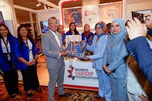 Investment, Trade and Industry Minister Tengku Zafrul Abdul Aziz receives a commemorative gift from Founder and Chairman of the Women Leadership Foundation, Dr Hafsah Hashim, during the ASEAN Women Economic Summit 2025 (AWES 2025), held on the sidelines of the 46th ASEAN Summit at the Kuala Lumpur Convention Centre (KLCC) on Sunday.