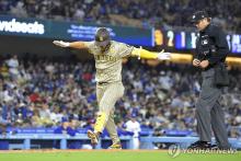 In this Associated Press photo, Kim Ha-seong of the San Diego Padres (L) celebrates after hitting a home run off Yoshinobu Yamamoto of the Los Angeles Dodgers during the clubs' Major League Baseball regular-season game at Dodger Stadium in Los Angeles on April 12, 2024. (Yonhap)