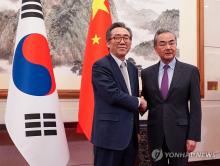 Foreign Minister Cho Tae-yul (L) poses for a photo with Chinese Foreign Minister Wang Yi ahead of their bilateral talks at the Diaoyutai State Guesthouse in Beijing, on May 13, 2024. (Yonhap)