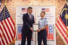 US Embassy Deputy Chief of Mission Manu Bhalla presenting the acceptance letter to Akmal Musyrif