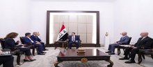 PM, Mohammed Shia Al-Sudani ( centre), the Chargé d'Affaires of the United States Embassy in Iraq, Steven Fagin, ( left)