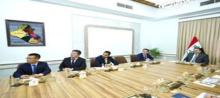Iraqi PM Muhammad al-Sudani (right) receives representatives  of Chinese Railway Company 