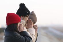 People pray facing out to sea in Sendai, Miyagi Prefecture, on March 11, 2025, the 14th anniversary of the earthquake, tsunami and nuclear disaster that devastated the country's northeast. (For editorial use only)(Kyodo)