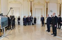 Presidents of Azerbaijan and Kazakhstan watch the ceremony marking the arrival of container train from China's Xi'an terminal to Baku's Absheron station via a video link