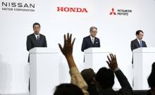 (From L) Presidents of Nissan Motor Co., Honda Motor Co. and Mitsubishi Motors Corp. -- Makoto Uchida, Toshihiro Mibe and Takao Kato -- attend a joint press conference in Tokyo on Dec. 23, 2024. (Kyodo)