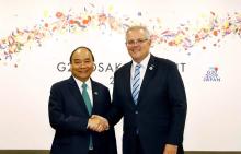 Prime Minister Nguyen Xuan Phuc (left) and his Australian counterpart Scott Morrison during G20 Summit in Japan in June 2019. (Photo: VNA)